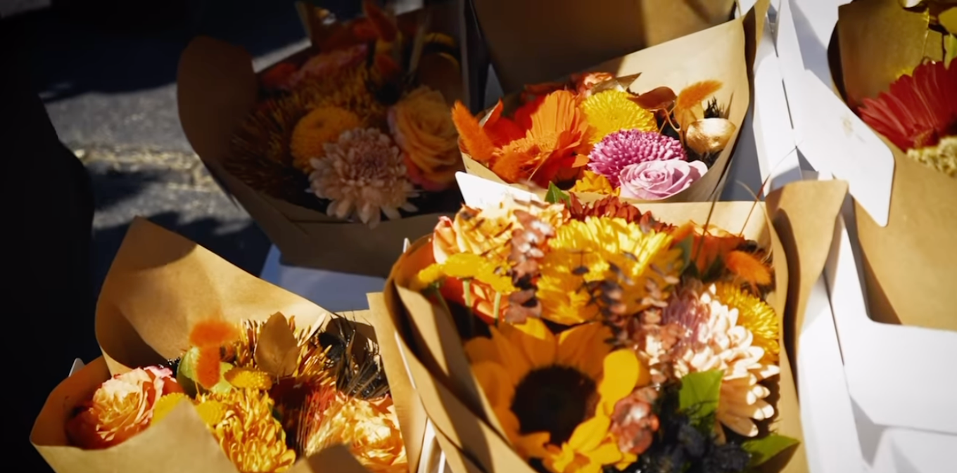 Fall flower bouquets wrapped in kraft paper on a market table